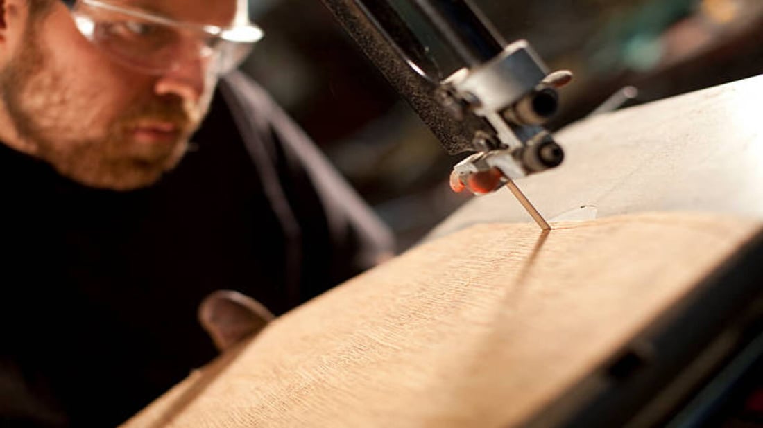 man-using-a-bandsaw