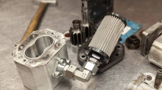 Where is the hydraulic suction filter located?